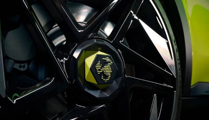 Close-up of a car wheel with a yellow scorpion logo on the centre cap.