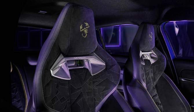 Black car seats with patterned upholstery and illuminated logo on the headrests.