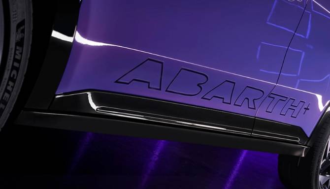 Purple car with ABARTH logo on the lower side panel, partial view of wheel.