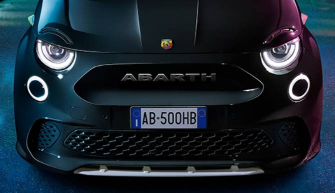 Front view of a black Abarth car with prominent headlights.