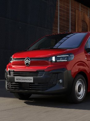 van driving past a building