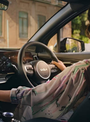 woman seat in the front seat of a KIA