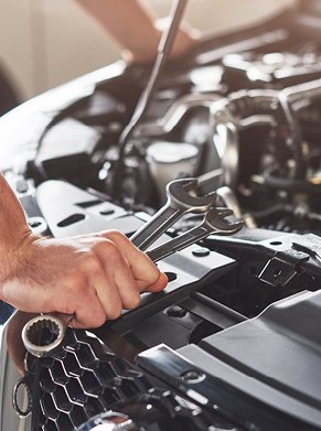 person holding spanners