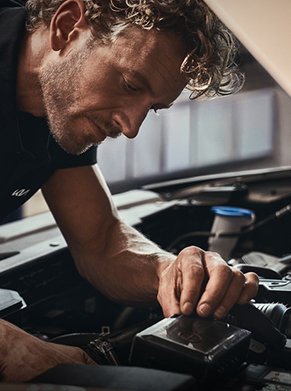 man looking into engine