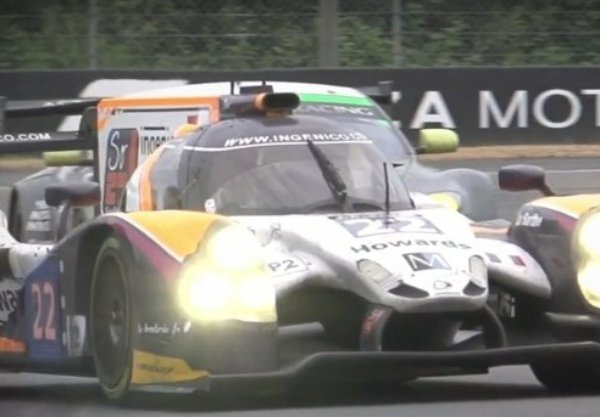 Race car with number 22 in front on a track, another car close behind.