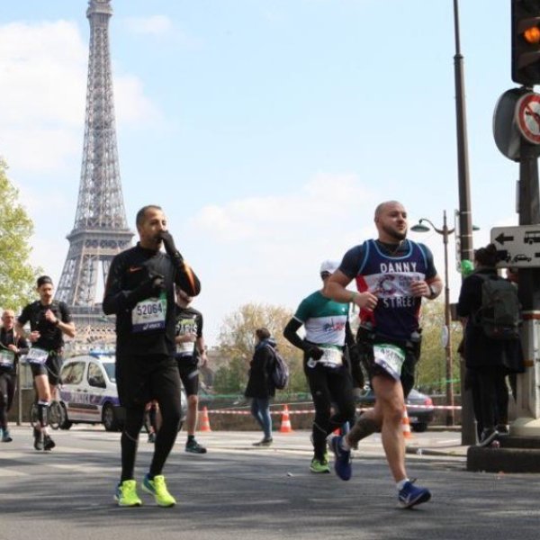 Runners participating in a marathon near the Eiffel Tower, Paris.