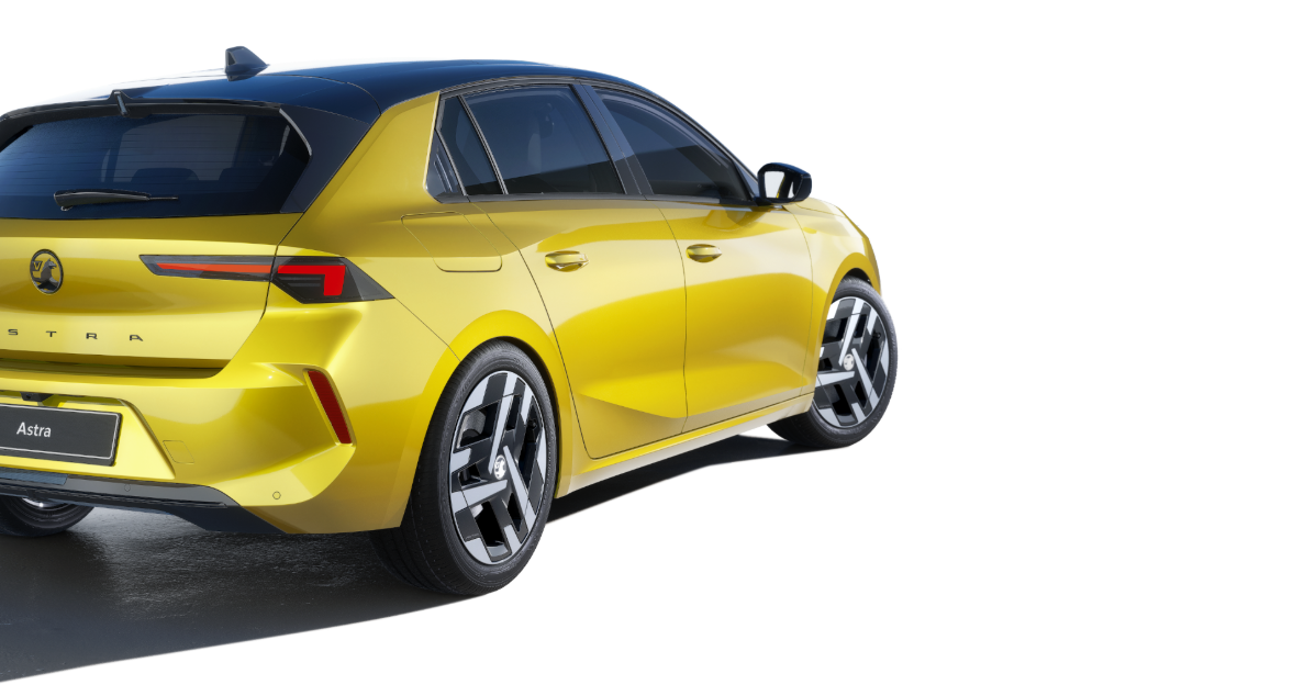 Yellow hatchback car viewed from the rear side.