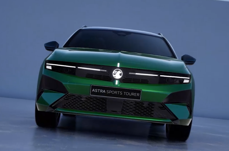 Green Astra Sports Tourer car viewed from the front against a plain background.