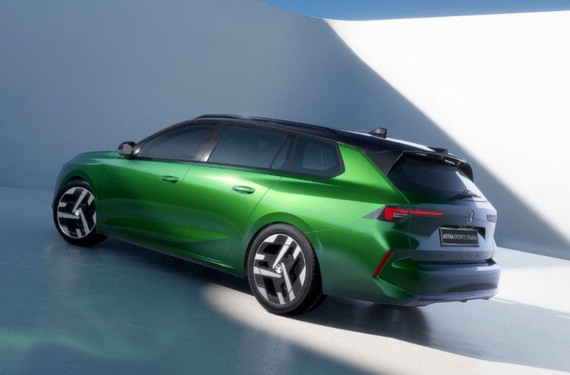 Green estate car with a black roof, rear view showing modern design and alloy wheels.