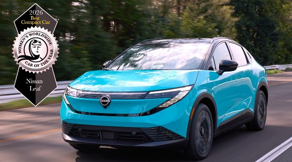 Turquoise Nissan Leaf driving on a road, awarded 2026 Best Compact Car.