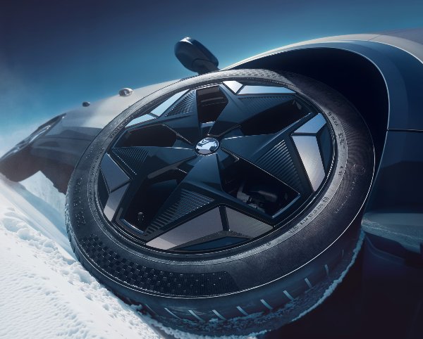 close up image of the wheel of a car with snow on the ground