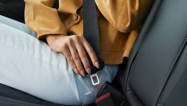 A woman fastening her seatbelt in the Civic