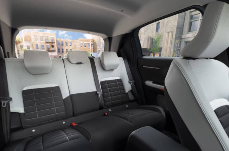Rear seats of a car with black and grey upholstery, view from the front seat.