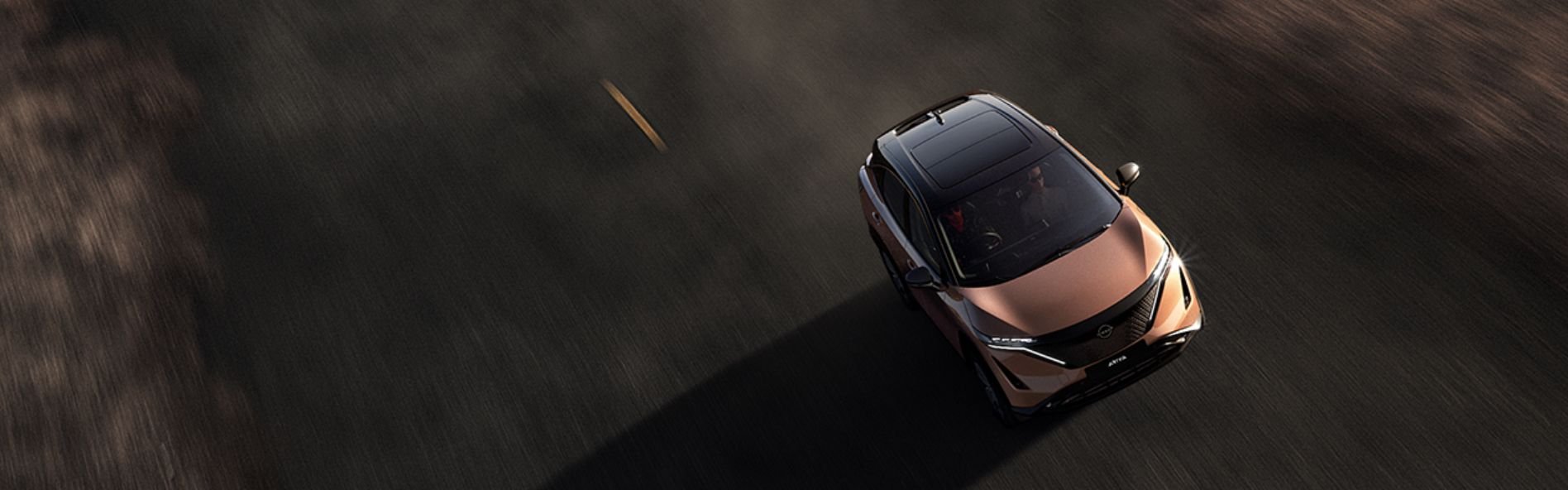 Birds eye view of the Ariya driving on a desert road