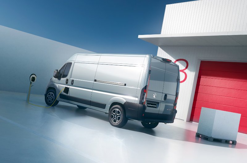 Van parked in front of red garage door