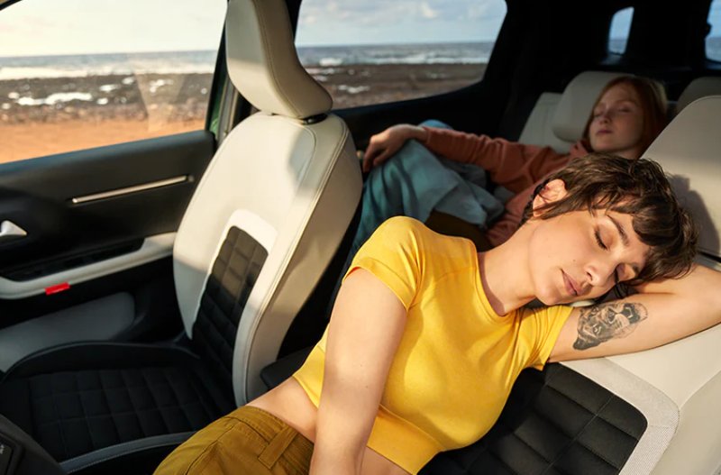 two people sleeping inside the car