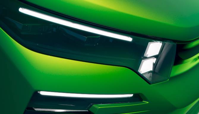 close up of headlights on green car