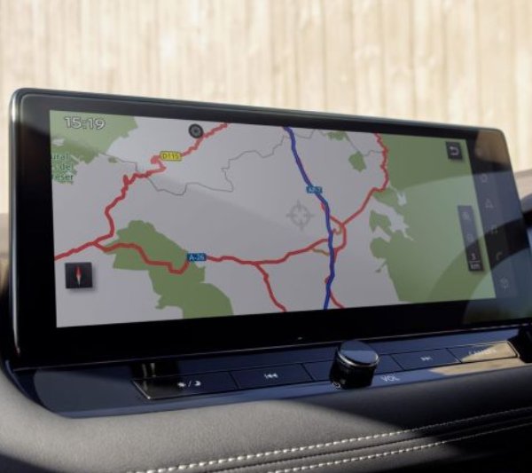 Car dashboard display showing a digital map with roads and routes.
