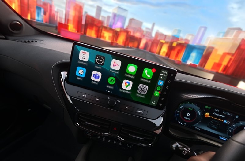 Car dashboard with a touchscreen display showing various app icons and steering wheel visible.