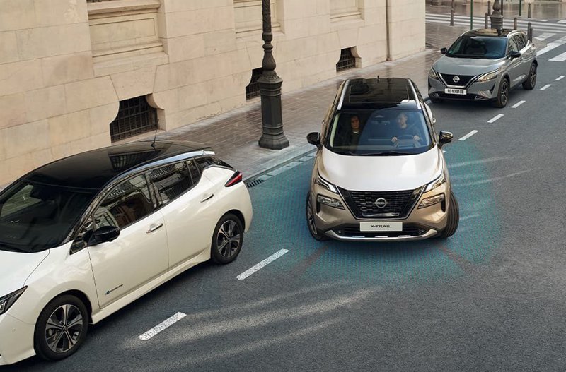 Cars demonstrating parking assist technology on a street.