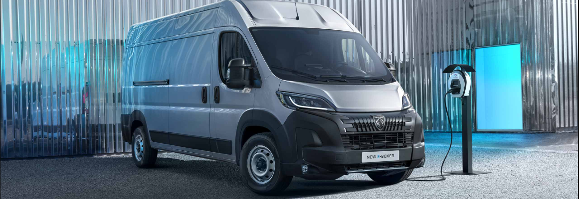 van parked on charge outside of a metal building