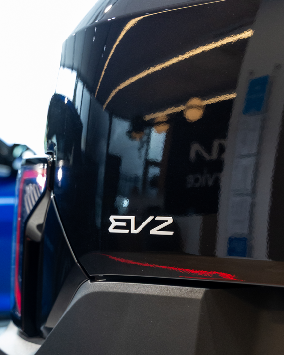 Close-up of a car labeled EV2 with Howards Motor Group branding.