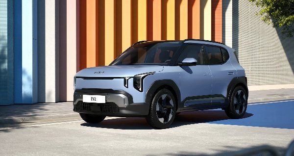 Silver SUV parked in front of a colourful striped wall.