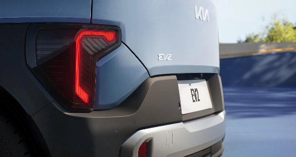 Close-up of a grey car's rear, showing the tail light and EV2 badge.