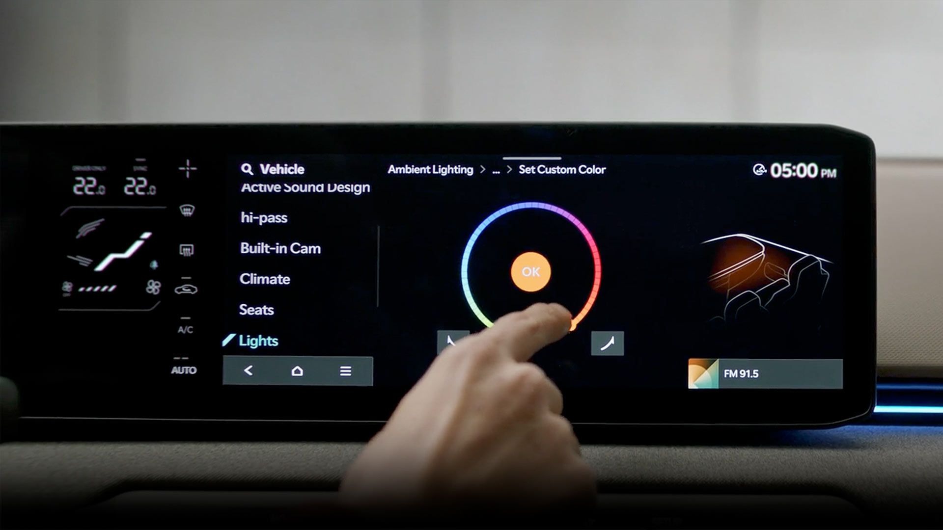 Touchscreen car dashboard with a finger selecting ambient lighting colour.
