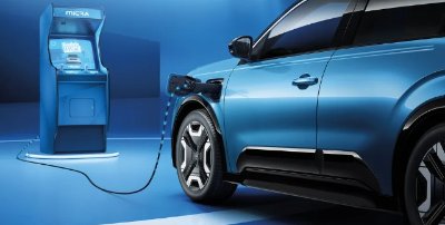 Electric car charging at a blue station.