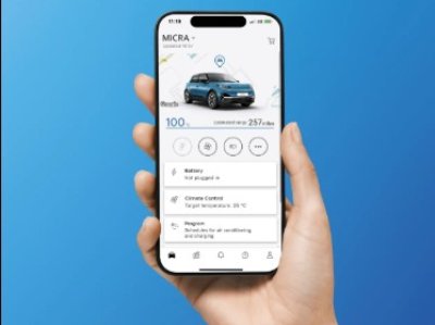 Person holding a smartphone displaying a car management app screen.