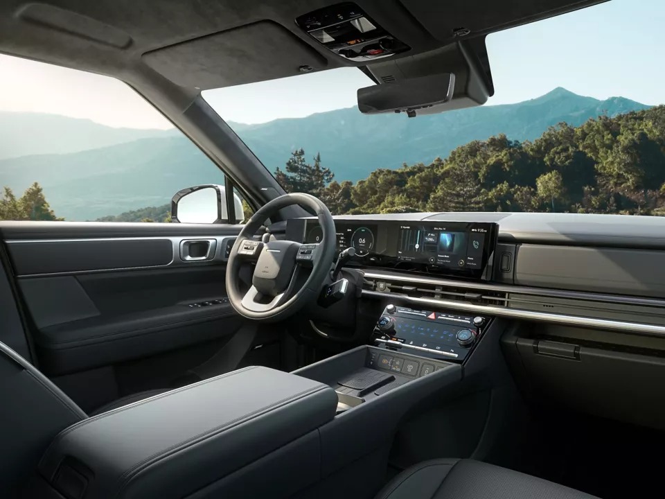 Interior of a modern car showing steering wheel and dashboard display.