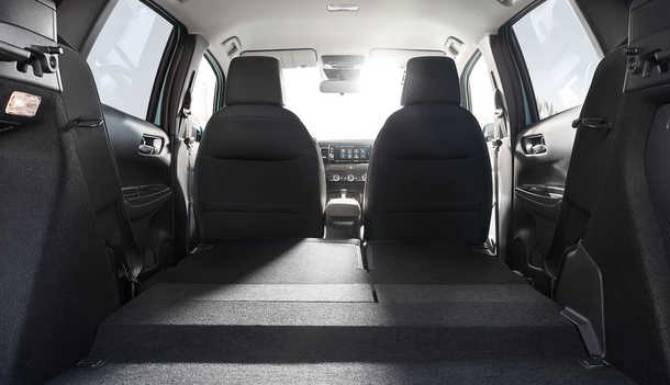 Car boot with folded rear seats offering extended cargo space.