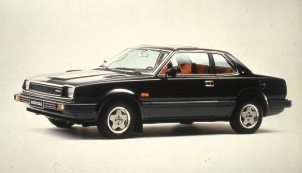 Black Honda coupe car with orange interior, side view.