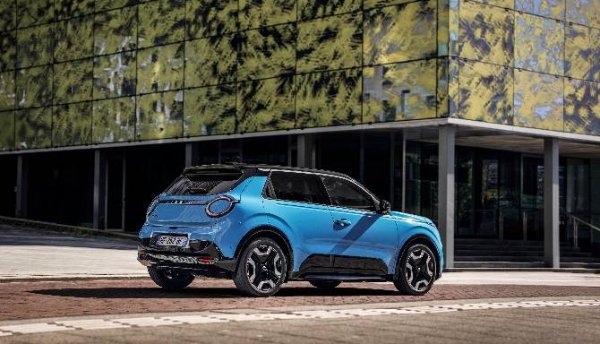 Blue compact SUV parked by a modern building.