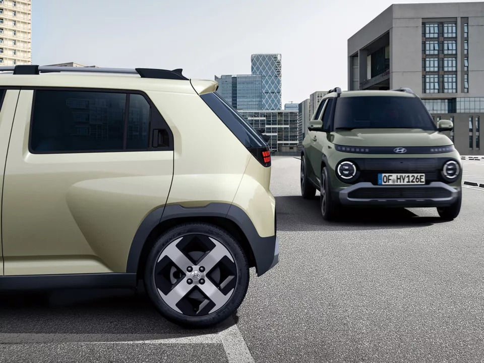 Two compact SUVs parked in an urban setting, one facing forward.