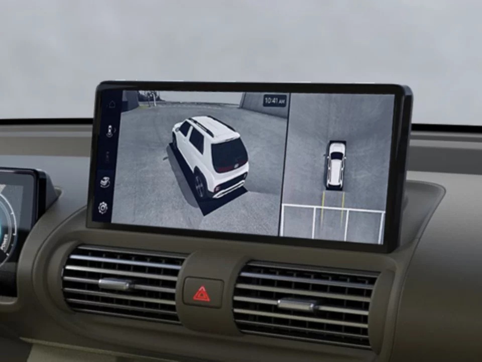 Car dashboard showing a rear parking camera display.
