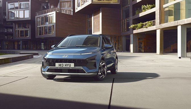 Blue Hyundai car with number plate H13 HYU parked on a paved surface.