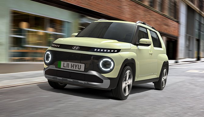 Green SUV driving on a city street.