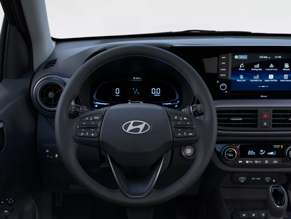 Interior view of a Hyundai car dashboard and steering wheel, showing digital displays.