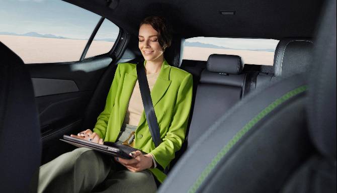 A woman sat in row 2 using an ipad