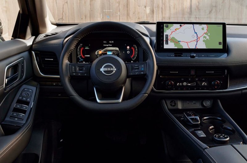 Interior view of a Nissan car dashboard with touchscreen and steering wheel.