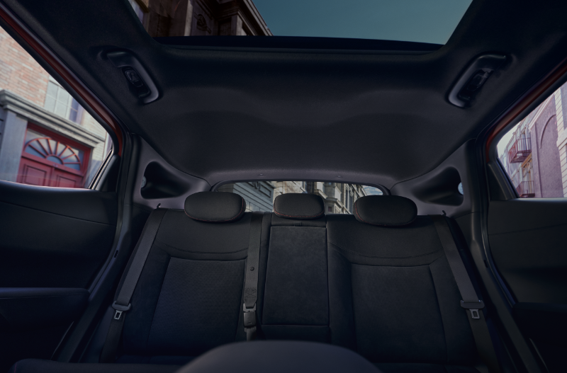 View of a car's interior showing rear seats and panoramic sunroof.