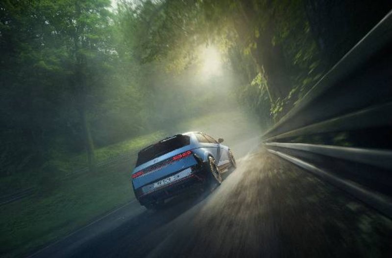car driving through the forest on road