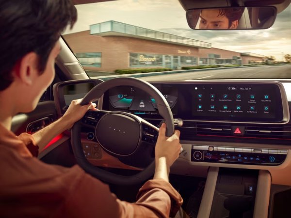 person driving the car showing you the safety features