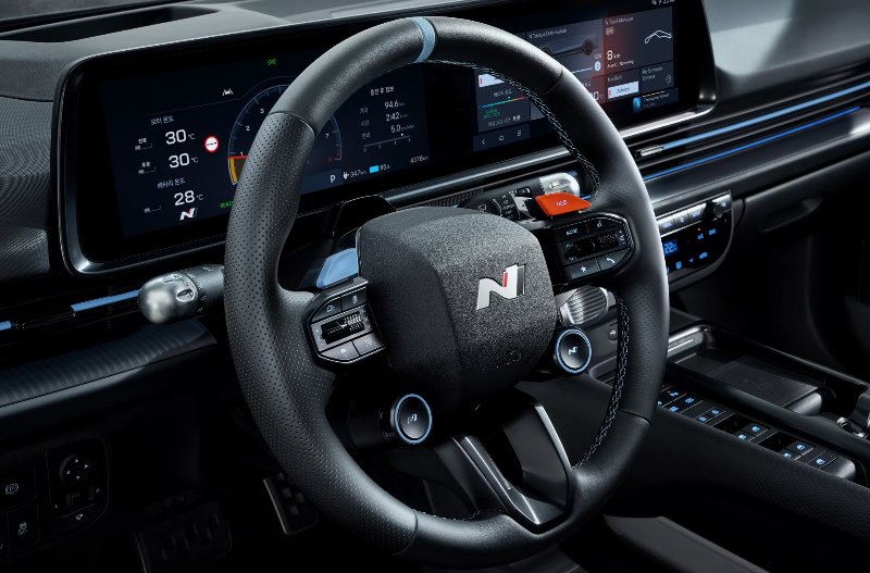 close up of the front interior of a car focusing on the steering wheel.
