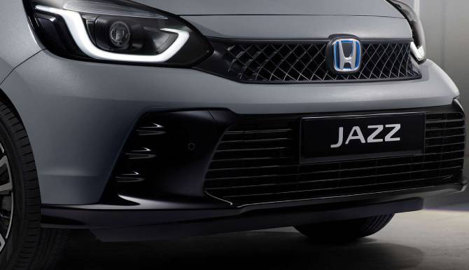 Close-up of a Honda Jazz car front with a focus on the grille and headlight.