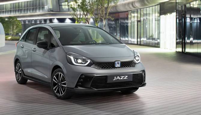 Silver Honda Jazz parked on a modern street scene.
