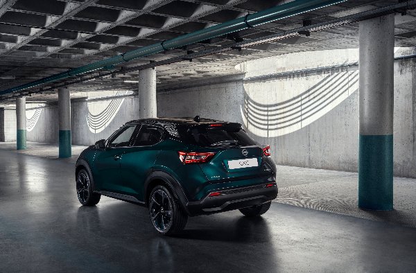 Dark green car in an underground parking area, view from the rear side.