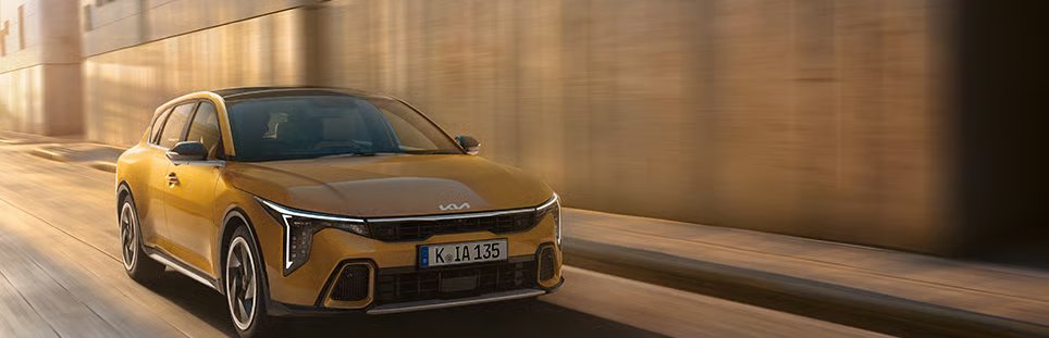Yellow car driving down the road